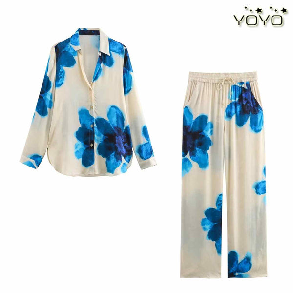Silk-like women's floral print set with blue watercolor flowers, featuring button-up shirt and wide-leg pants.