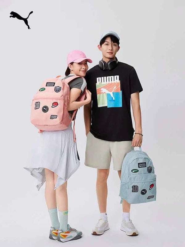 PUMA backpacks in pastel pink and light blue with badges, worn by young models, stylish and practical for school and casual use