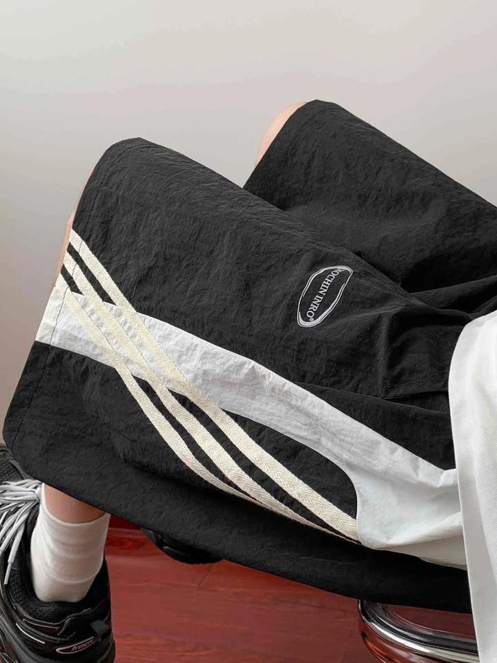 black sports shorts with white side stripes and adjustable waistband for casual and daily activities