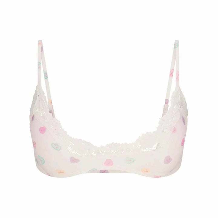 SKIMS Fits Everybody white lace scoop bralette with colorful heart prints and adjustable straps