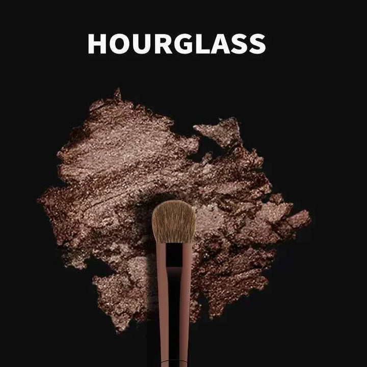 Hourglass professional makeup brush set with soft bristles and elegant leather case on dark background