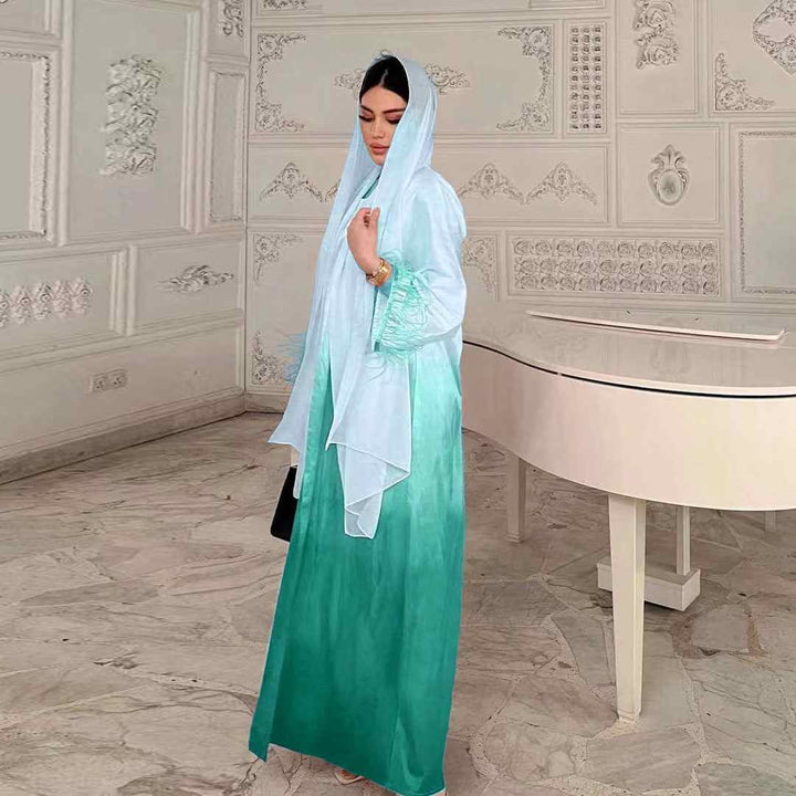 Elegant satin gradient abaya with feather-trimmed sleeves, suitable for Middle Eastern fashion.