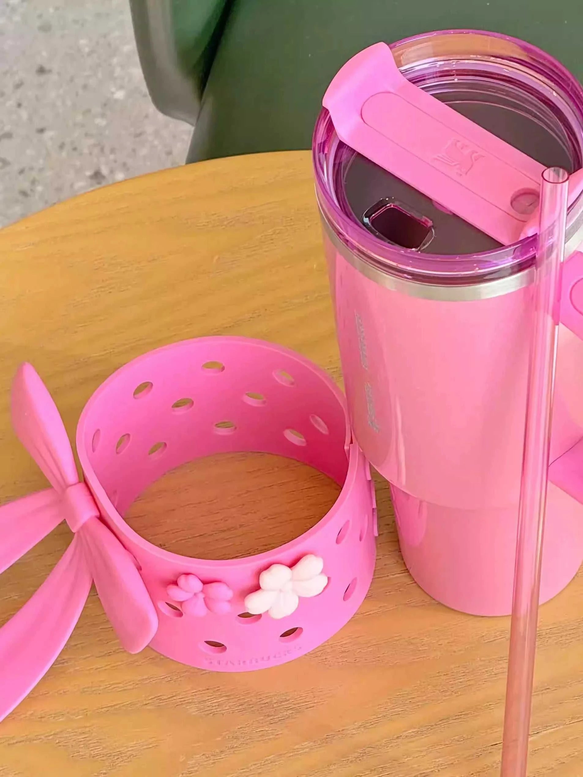 Tumbler Stanley Starbucks وردي مع إكسسوار فيونكة.