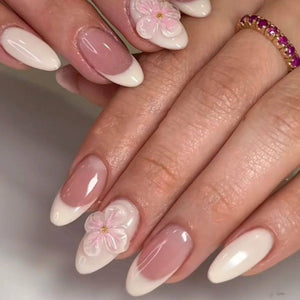 أظافر تركيب Press-on Nails بتصميم زهور بارزة وألوان وردية.