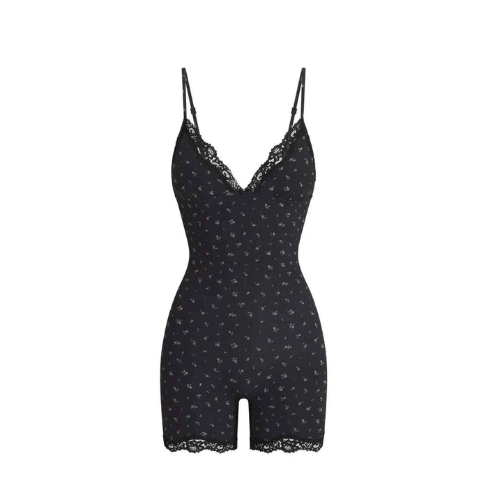 Black lace bodysuit with soft floral prints and adjustable straps, featuring delicate lace trim on chest and edges.