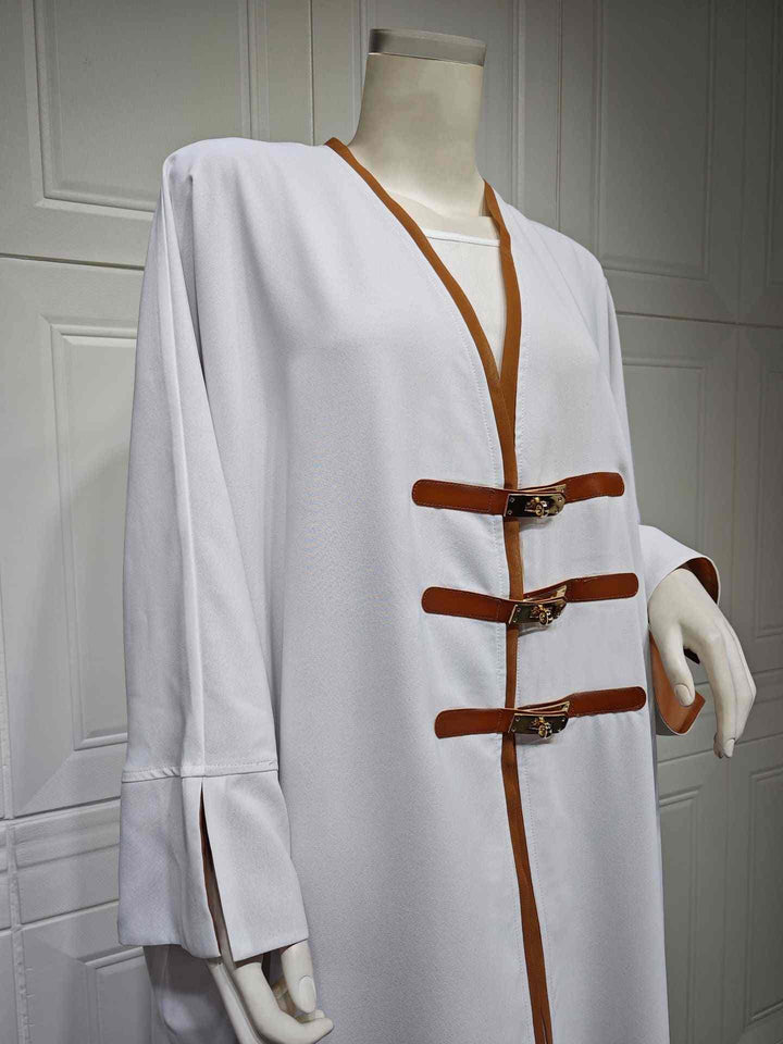 Modest Turkish fashion abaya with leather belts and color-blocked details.