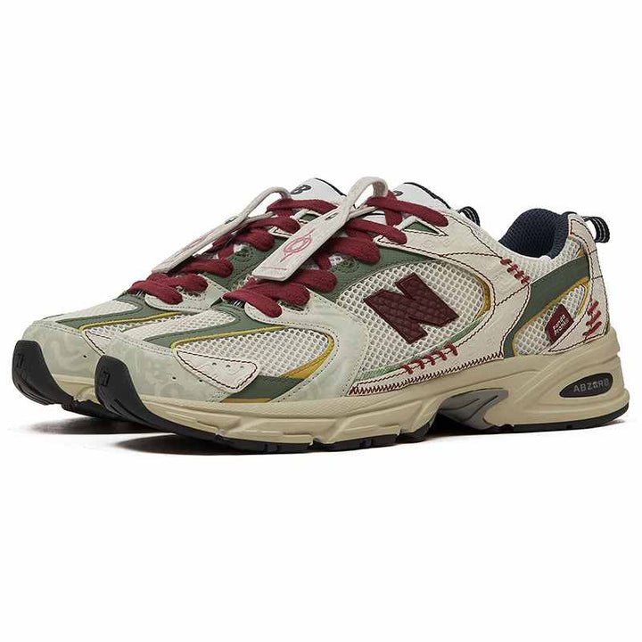 New Balance 530 PandaPrank Limited Edition sneakers in beige, olive green, and dark red with intricate embroidery and premium materials.