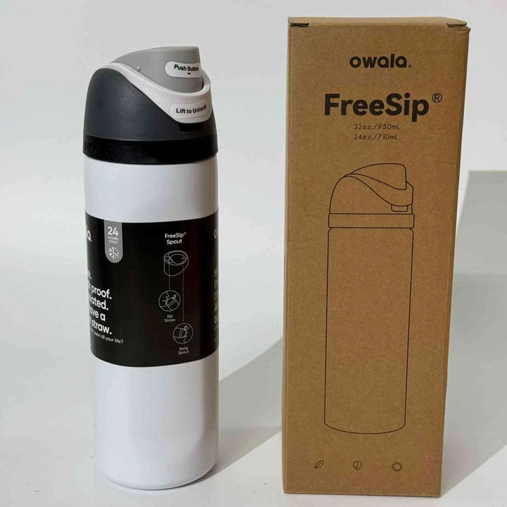 Owala Thermos Cup FreeSip stainless steel insulated water bottle with dual drinking spout and leak-proof design next to its cardboard packaging