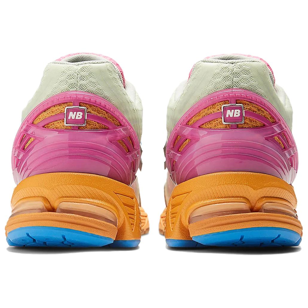 Rear heel view of a pair of Action Bronson x New Balance shoes 1906R model "Rosewater," featuring glossy hot pink molded TPU support cages with square NB logos, textured orange knit underlays, pale green mesh collars, vibrant orange N-ergy cushioned midsoles, and bright blue rubber outsoles.