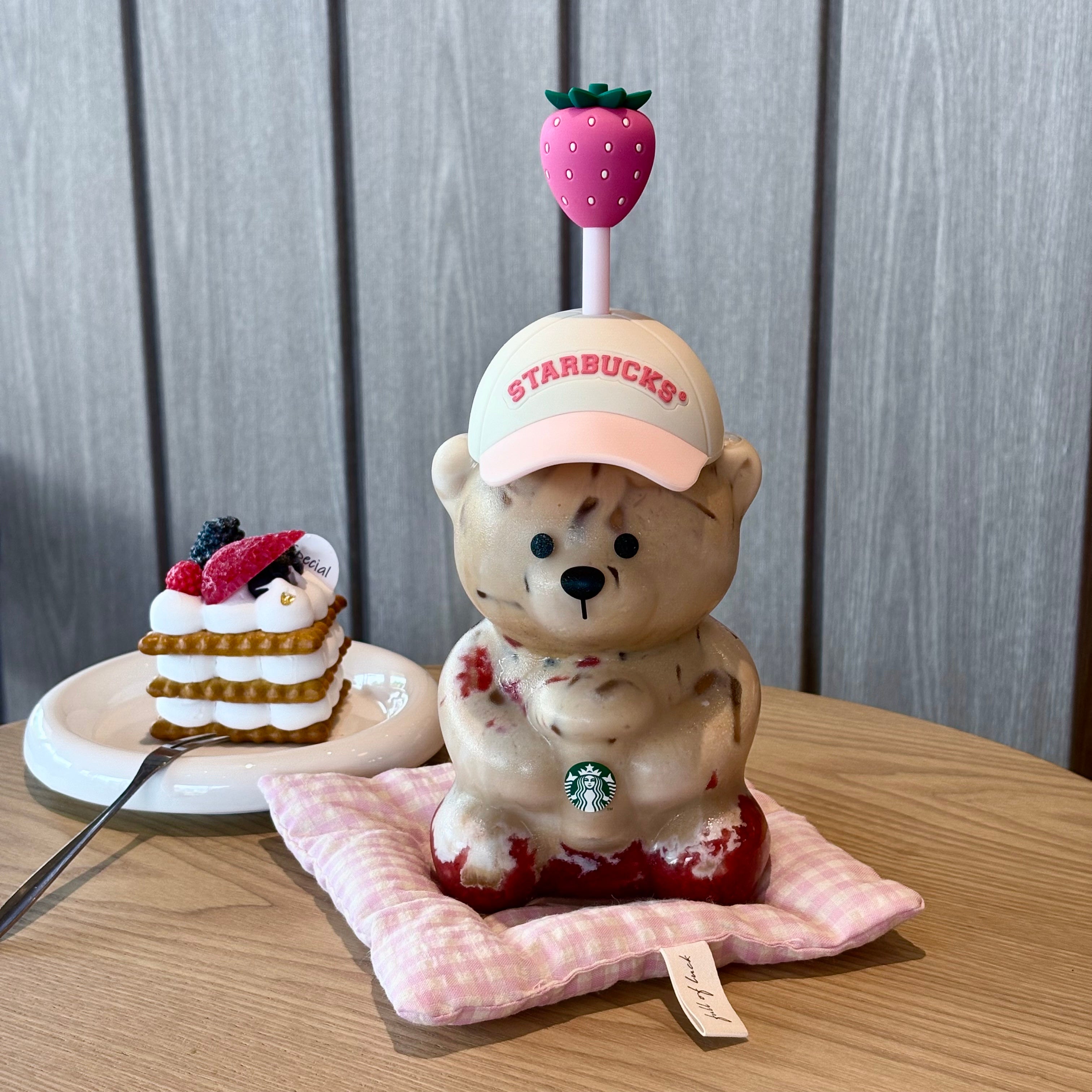 A full shot of the starbucks bear cup 2026 pink with its unique strawberry straw, presenting كوب ستاربكس الدبدوب الوردي 2026 آخر اصدار.