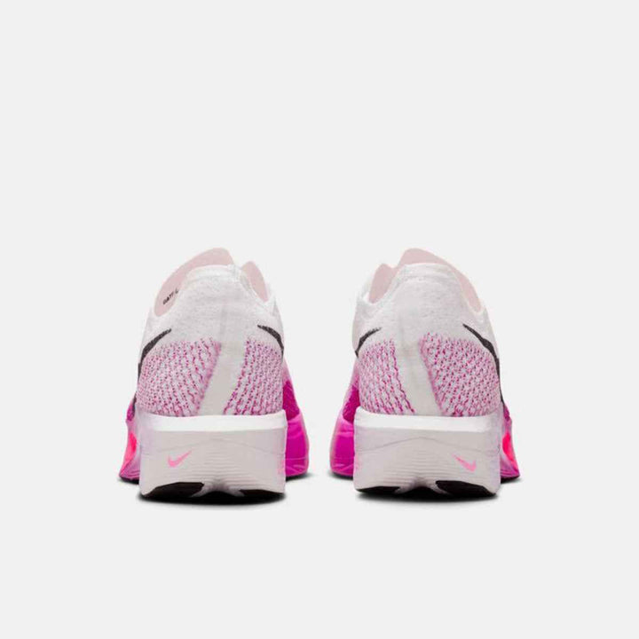 Rear view of Nike Vaporfly shoes in white and pink, featuring lightweight Flyknit design and full-length carbon plate.