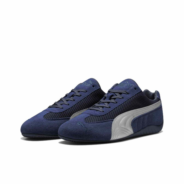 Puma Speedcat OG navy suede sneakers with silver Puma logo, inspired by Formula 1 racing shoes, featuring breathable mesh and low-profile sole