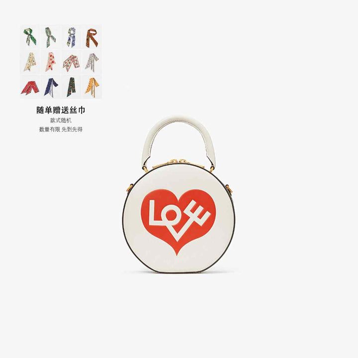 Round Kate Spade crossbody bag with "LOVE" print, adjustable strap, and multiple pockets.