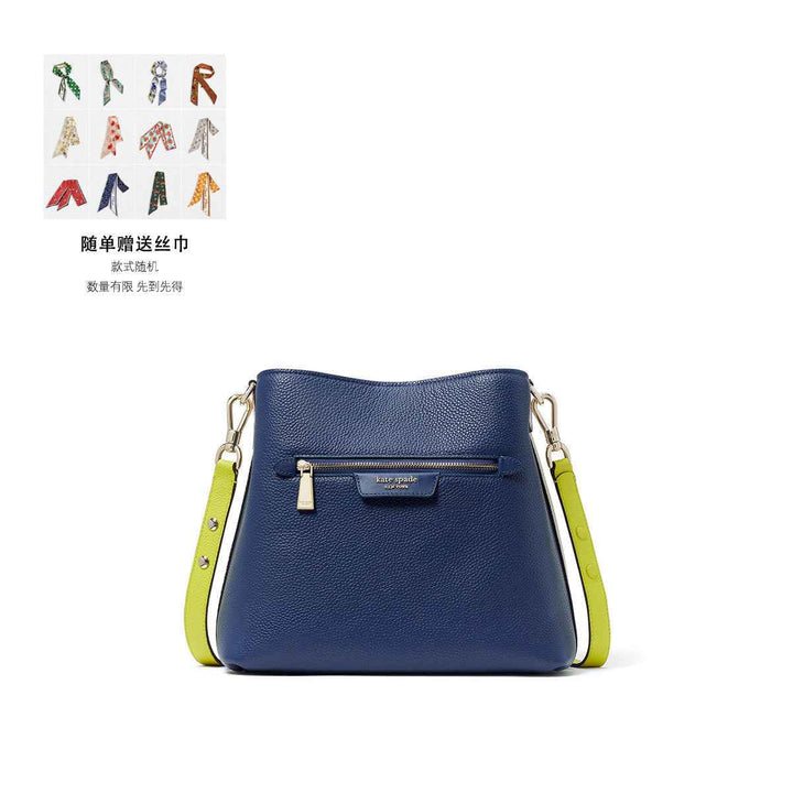 Kate Spade royal blue crossbody bag with lemon accents, pebbled leather, and adjustable strap.