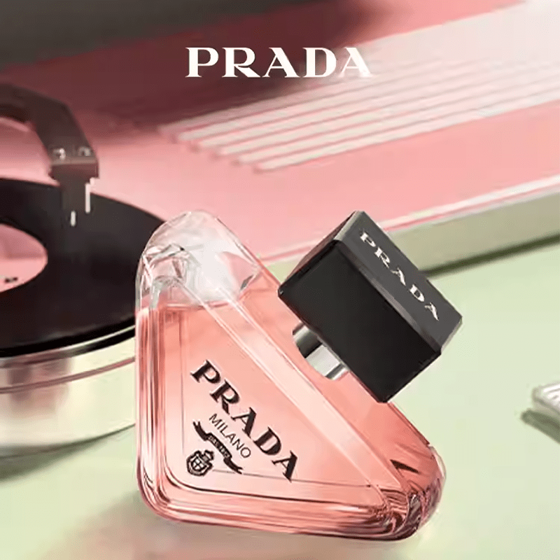 عطر برادا الوردي على سطح لامع