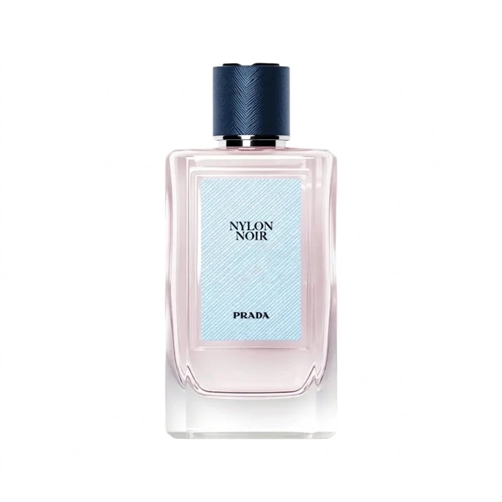 عطر برادا نسائي Black Nylon بزجاجة شفافة محاطة بزهور برتقالية وبيضاء