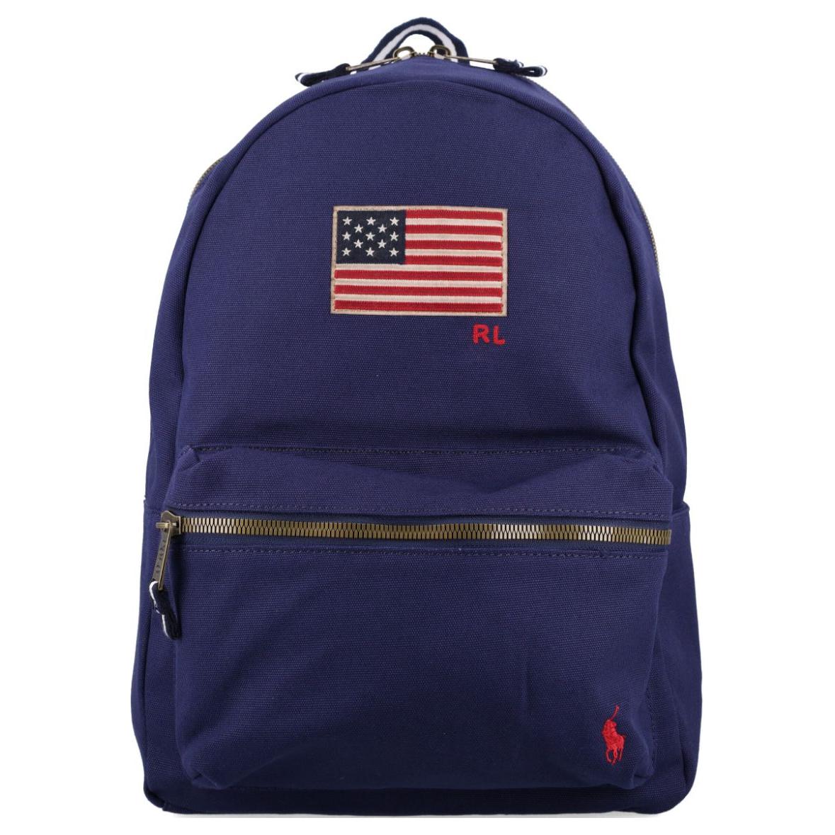 An authentic Polo Ralph Lauren navy blue backpack featuring an embroidered US flag, red pony logo, and brass zipper, ideal for back-to-school and daily use.

حقيبة ظهر Polo Ralph Lauren باللون الكحلي أصلية تتميز بتطريز العلم الأمريكي وشعار المهر الأحمر والسحاب النحاسي، مثالية للعودة للمدرسة والاستخدام اليومي.