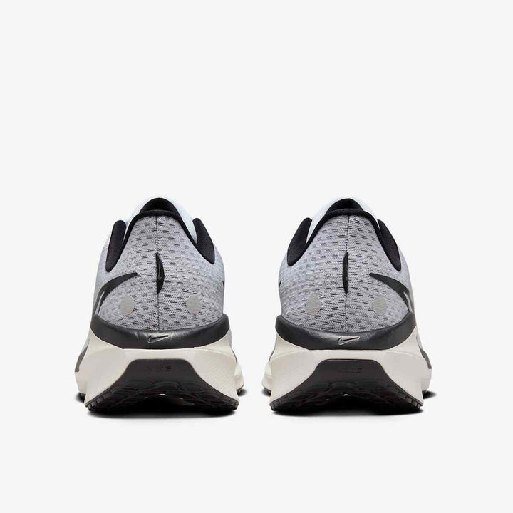 White and black Nike ZoomX Pegasus 40 running shoes, rear view displaying mesh upper and rubber outsole.