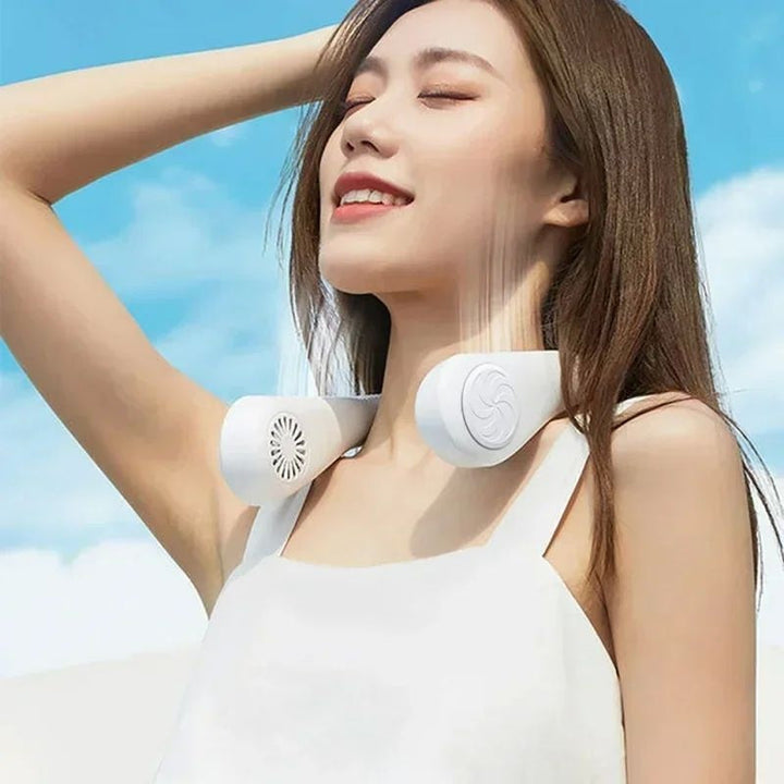 Woman wearing a white portable mini neck hanging fan against blue sky background