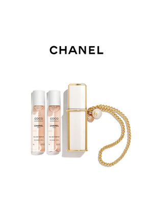 CHANEL Coco Mademoiselle refillable purse spray set featuring a white and gold perfume case with a golden chain bracelet, a pearl bead, a camellia charm, and two fragrance refills under the CHANEL logo.