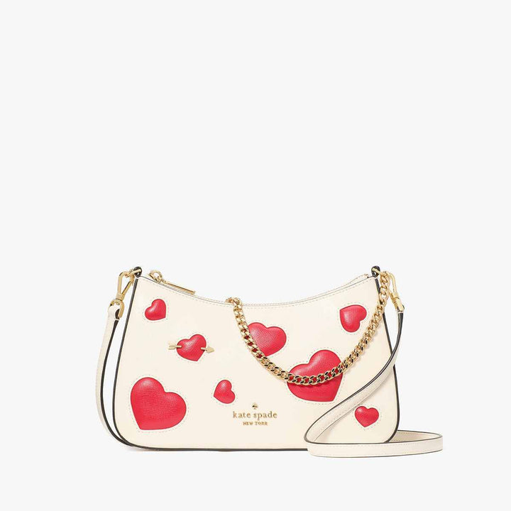 Kate Spade heart-patterned ivory leather shoulder bag with red accents and gold chain.