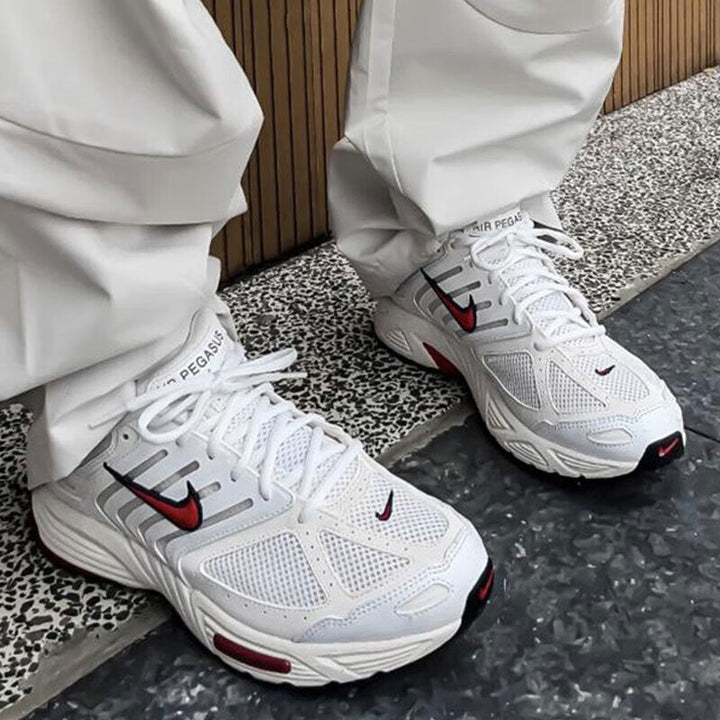 Nike Air Pegasus 2006 sneakers in sail, coconut milk, and black, featuring comfortable midsole cushioning and 3D Nike logo details.