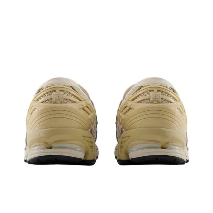 Rear view of beige New Balance 1906 lightweight mesh and leather sneakers with rubber sole and lace closure