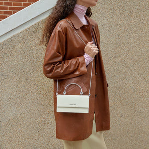 حقيبة Charles & Keith بمقبض علوي معدني وتصميم Crossbody.