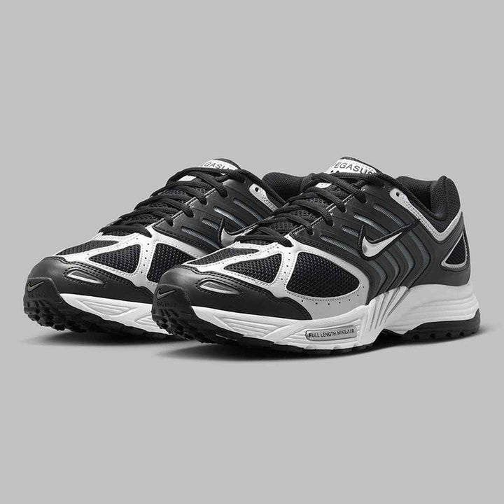 Nike Air Pegasus 2006 sneakers in black and silver with reflective logo accents, lightweight mesh design, and durable outsole.