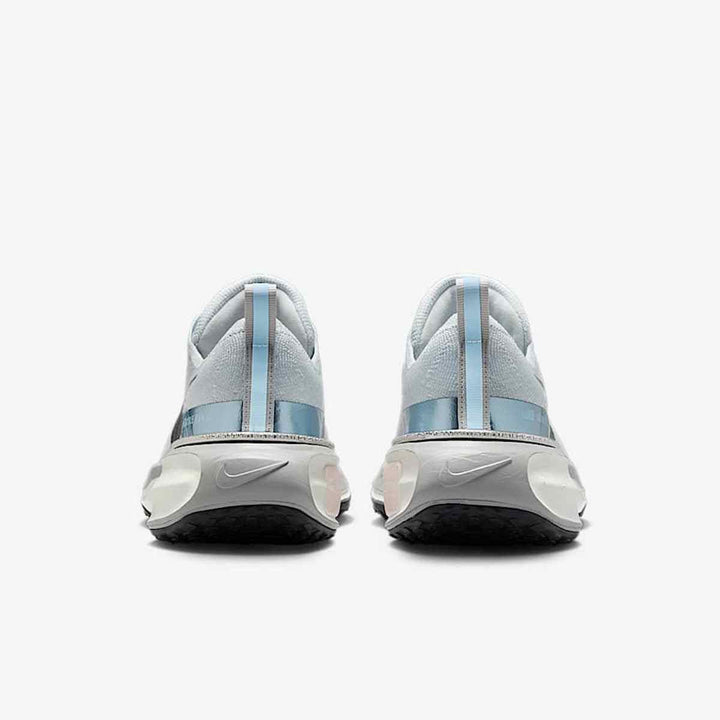 Blue Nike ZoomX Vaporfly running shoes with lightweight mesh upper and reflective logo.