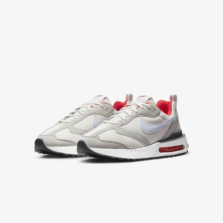 Nike Air Max Dawn sneakers in gray and white with red accents, featuring visible air cushioning and durable leather-mesh blend.