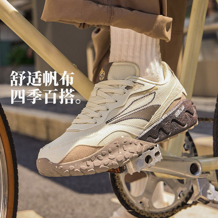 361° Shortbread Series men's retro running shoes with winter texture, beige and brown, on bicycle pedal.