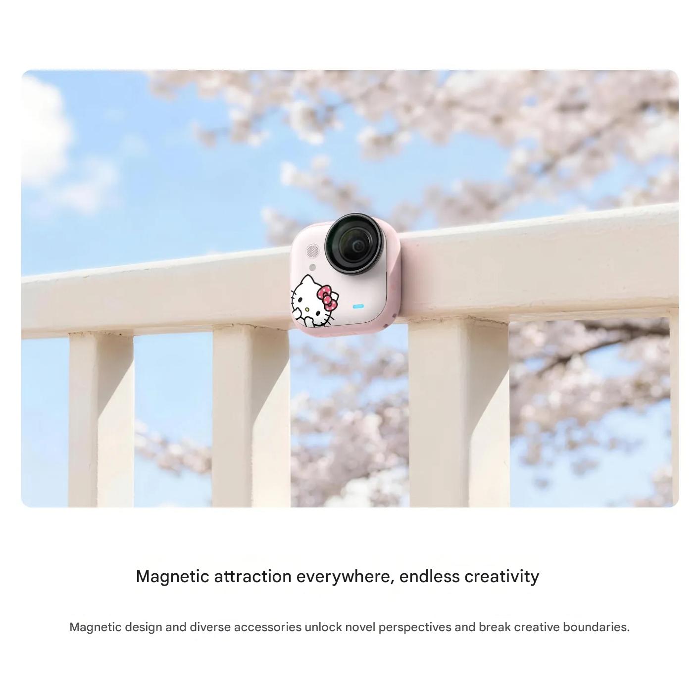 The pink Hello Kitty Insta360 GO Ultra camera mounted magnetically on a white outdoor railing under a clear blue sky.