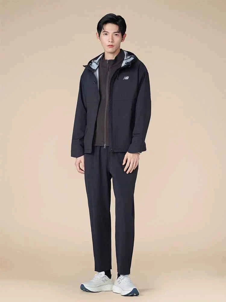 Full-length view of a male model wearing full sportswear paired with a comfortable حذاء نيو بالانس suitable for running or daily walks.