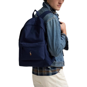 A man wearing an authentic Polo Ralph Lauren navy blue backpack, perfect for back-to-school style and casual outfits.

رجل يرتدي حقيبة ظهر Polo Ralph Lauren أصلية باللون الكحلي، مثالية لأسلوب العودة للمدرسة والإطلالات اليومية.