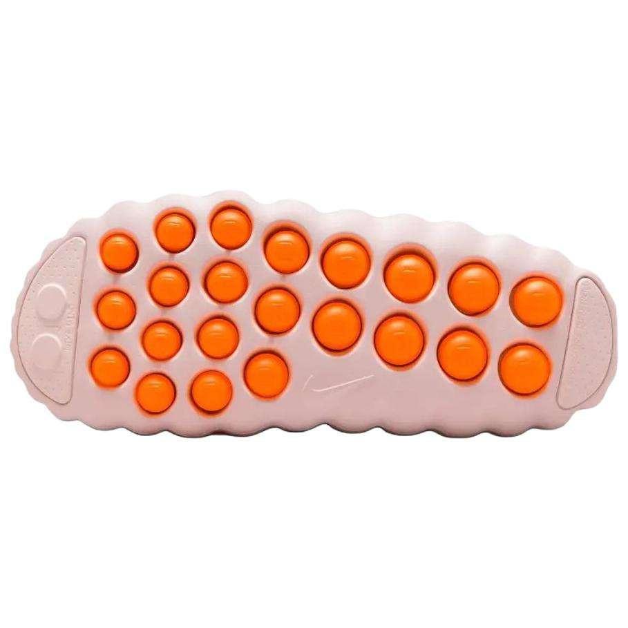 Bottom traction sole view of the Nike Mind 001 baby pink, featuring the textured orange grip pods designed for stability and comfort.