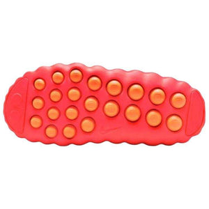 Bottom sole view of the Nike Mind 001 in neon orange, displaying the signature orange grip pods designed for traction and comfort.