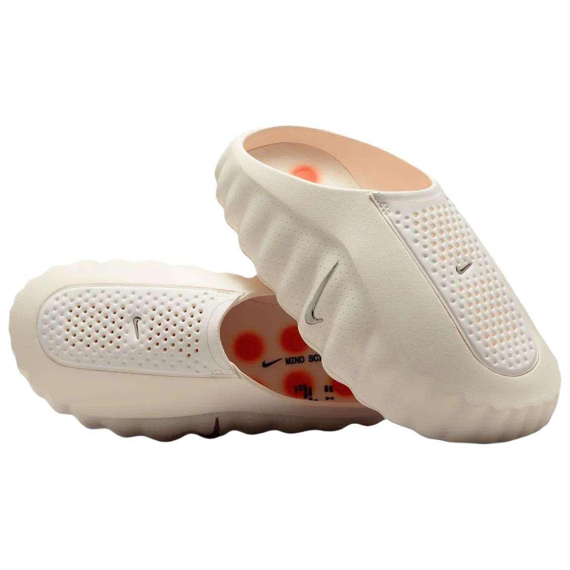Angular view of a pair of Nike Mind 001 off-white shoes, displaying the textured breathable mesh upper and slip-on design.