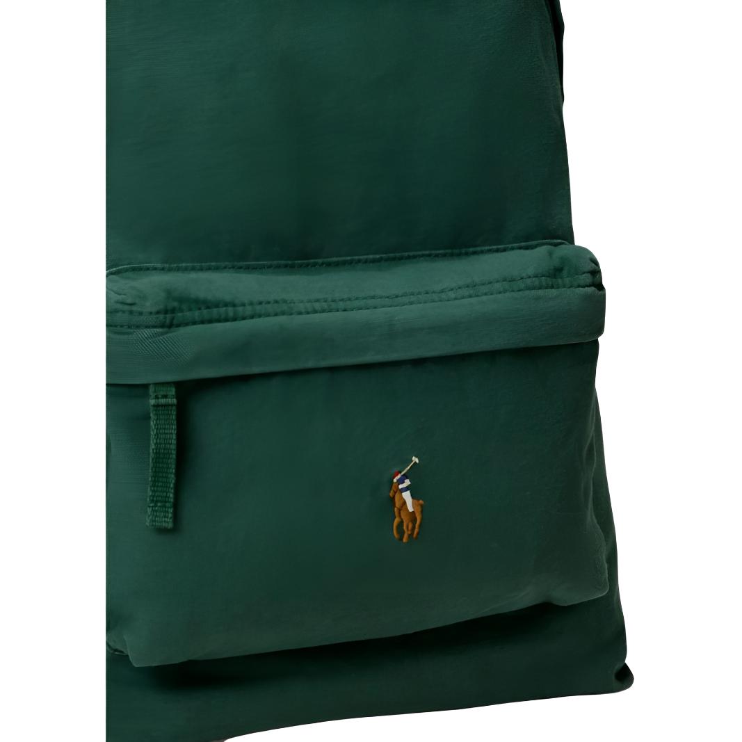 Detailed close-up of the front zipped pocket and iconic colorful embroidered pony logo on an authentic green Ralph Lauren backpack.

(لقطة قريبة مكبرة للجيب الأمامي ذي السحاب وشعار المهر المطرز الملون الشهير على حقيبة ظهر رالف لورين أصلية باللون الأخضر.)