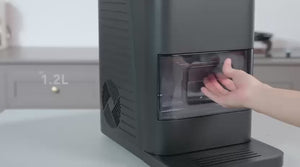 A video showing a user pulling out the clear ice storage tray from a modern gray ice maker machine. and a user guide proess 
