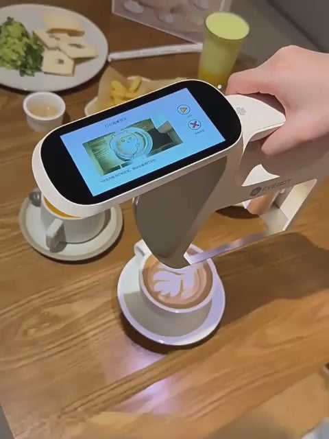 Practical demonstration of الطباعة على القهوة والطعام (Printing on coffee and food) using the easy handheld device mechanism.