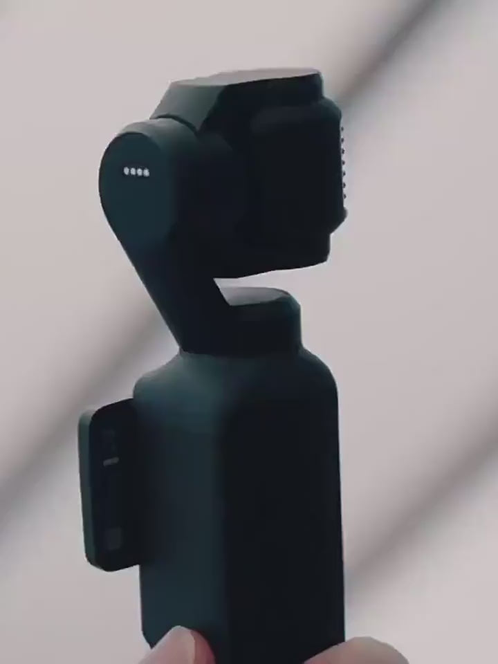 A close-up view of the sleek black design and rotating stabilization axes of the DJI Osmo Pocket 4 handheld camera.
