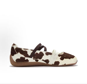 Puma Speedcat Ballet cow print brown white women shoes profile view showing animal pattern texture.