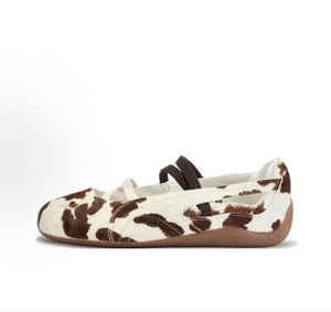 Puma Speedcat Ballet cow print brown white shoes side view displaying faux fur upper and crossover straps.