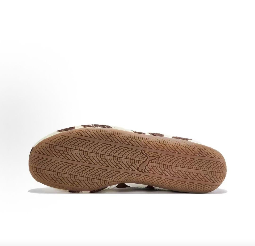 Puma Speedcat Ballet cow print brown white shoes bottom view showing gum rubber outsole pattern.