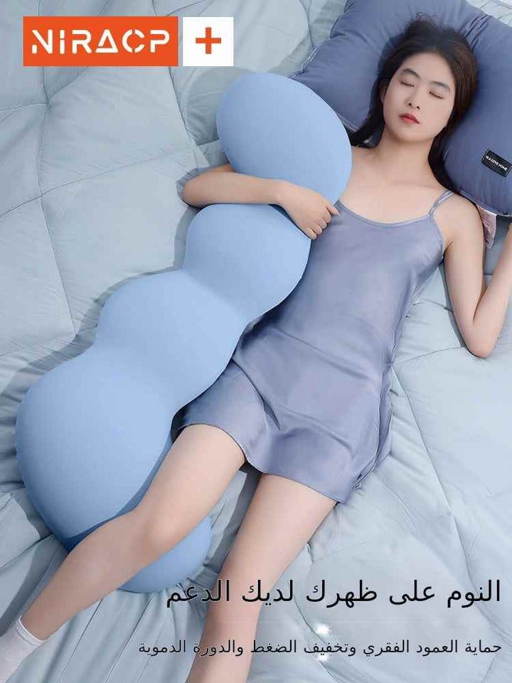 pregnant woman sleeping with ergonomic pillow on the bed