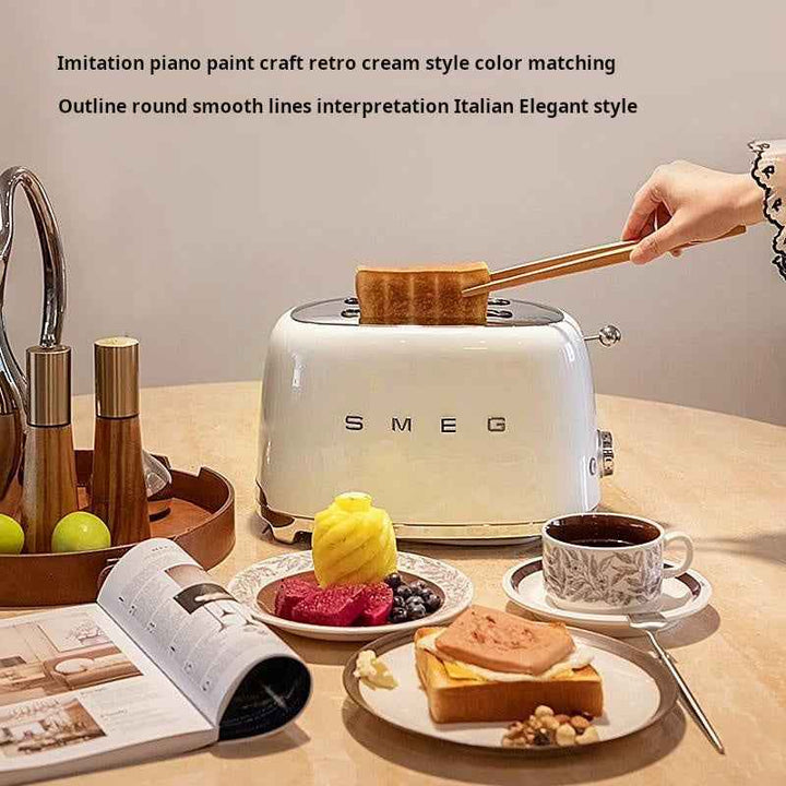 Italian SMEG toaster in cream with retro piano paint finish on kitchen table with breakfast and coffee