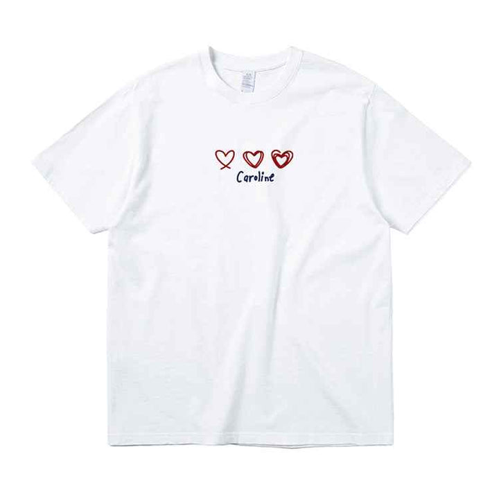 White Caroline Hearts t-shirt with embroidered red hearts and elegant handwritten "Caroline" text, made from 100% Xinjiang cotton, casual fit.