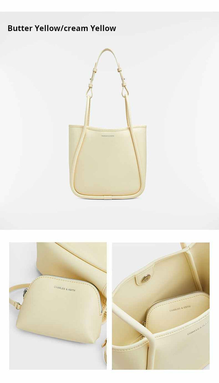 Multi-color CHARLES & KEITH shoulder bag in butter yellow with adjustable straps and spacious interior, made from durable synthetic leather.