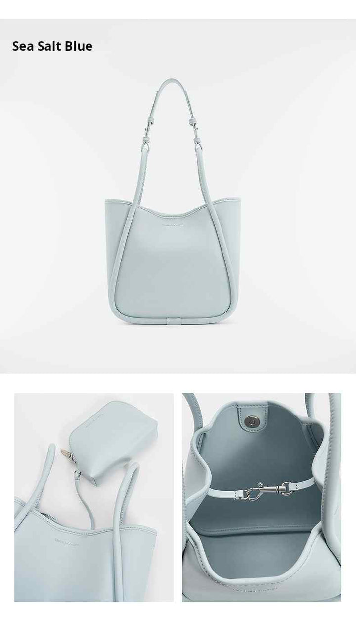 Multi-color CHARLES & KEITH shoulder bag in sea salt blue synthetic leather with adjustable detachable straps and spacious interior.